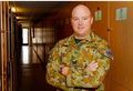 No 77 Squadron Association Deployments photo gallery - Exercise Red Flag. Sgt Cameron Keding, Life Suport Fitter, in fron of the massive hallway of lockers that house flying gear.  The lockers are three rows deep.